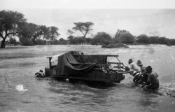 Cream lorry in middle of stream at Erundu River, between Otjiwarongo and Kalkfeld. Jan. 1934 
